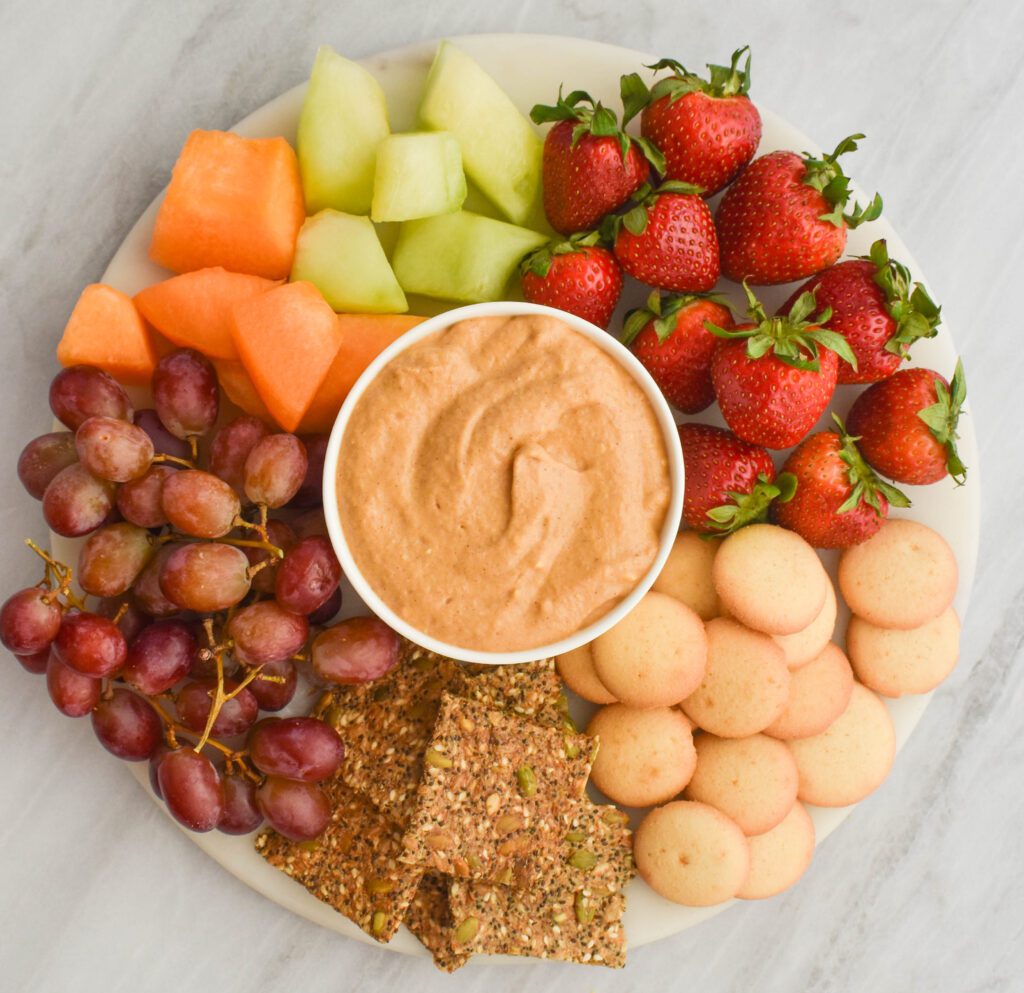 low-FODMAP pumpkin cheesecake dip on platter with fruit and cookies