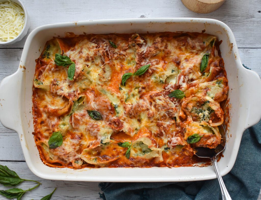 low fodmap stuffed shells horizontal in dish with spoon
