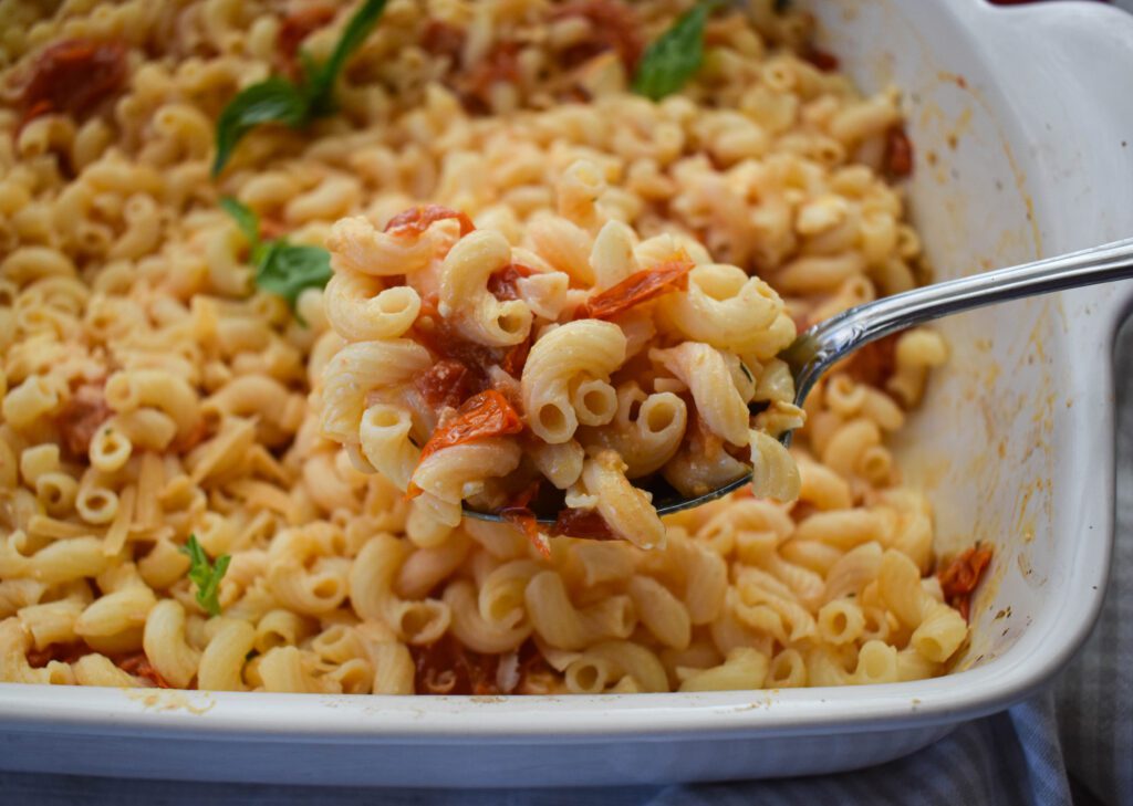 low fodmap feta baked pasta in casserole with macaroni spooning out