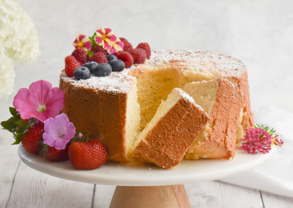 low fodmap chiffon cake on platter cut with flowers close up
